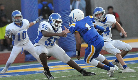Dashawn Martin (55) and Devyn Spurgeon (14) descend upon North Little Rock quarterback Karate Cotton (1). (Photo by Kevin Nagle)
