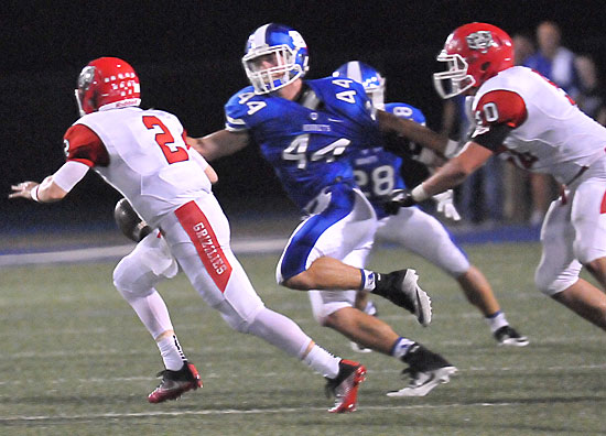 Bryant's Nathan Mayes (44) and Brooks Ellis (28) track Northside quarterback Max Frazier (2). (Photo by Kevin Nagle)