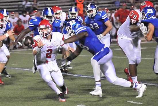 Marvin Moody gets to quarterback Max Frazier as he pitches the ball. Kajuan Robinson (99) and Hayden Knowles (33) follow the play. (Photo by Kevin Nagle)