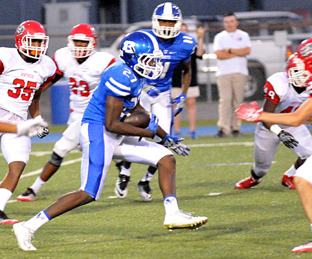 Bryant's Randy Thomas (27) runs back a kickoff through traffic with teammate Andre White (11) trailing the play. (Photo by Kevin Nagle)