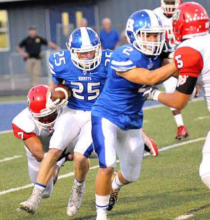 Landon Smith (2) tries to help clear the way for Seth Tucker (25). (Photo by Kevin Nagle)