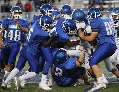 The Bryant freshman defense swarms to stop Conway Blue's Jabien Earl. (Photo by Rick Nation)