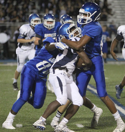 Austin Bailey (80) and Catrell Wallace (84) stand up a Conway Blue running back. (Photo by Rick Nation)