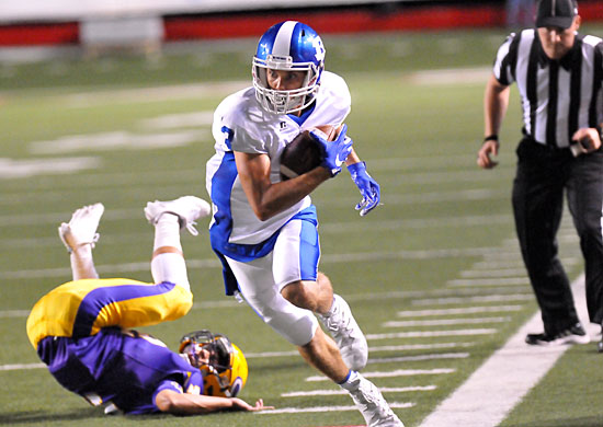 Reece Coates (3) walks the tightrope on the sideline, staying fair for a big run after the catch. (Photo by Kevin Nagle)