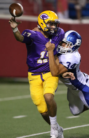 Bryant's Madre Dixon (34) hits Catholic quarterback Taylor Price as he gets rid of the ball. (Photo by Rick Nation)