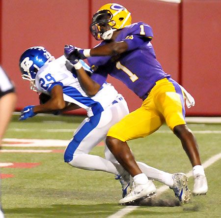 Andrew Hayes scores after an interception as Catholic's Samy Johnson tries to make a tackle. (Photo by Kevin Nagle)