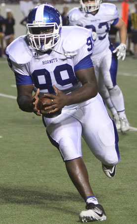 Sophomore Kajuan Robinson heads to the end zone after intercepting a tipped pass. (Photo by Rick Nation)