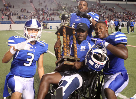 Bryant senior Phillip Isom-Green got to hold the Salt Bowl trophy thanks to his teammates. Isom-Green recently had surgery on his knee, which will deny him a chance to play his senior year at Bryant. (Photo by Rick Nation)