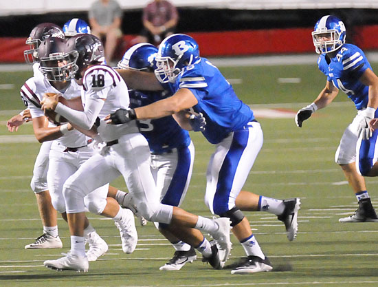 Bryce Thomas and Hayden Knowles pressure Benton quarterback Nate Beck as Nathan Mayes (44) gets into position to help. (Photo by Kevin Nagle)