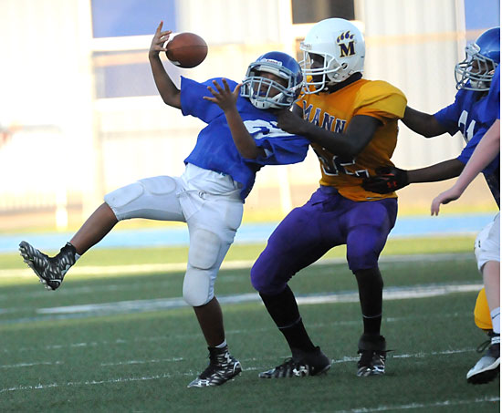 Bryant's Daylon Bland is collared by a Horace Mann defender for a loss. Bland was somehow able to retain possession on the play. (Photo by Kevin Nagle)