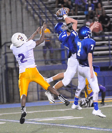 Austin Ledbetter intercepts a pass as teammate Aidan Adams (7) tries for it too in front of Horace Mann's Keith Green Jr. (Photo by Kevin Nagle)