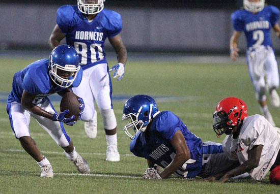 Christian Cain (5) scoops up a fumble caused in part by teammate Catrell Wallace (84) as teammates Austin Bailey (80) and Gavin Wells (2) trail the play. (Photo by Rick Nation)