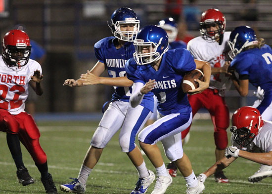 Jake Meadows (1) breaks a run with the help of a block from Emil Pritchard (70). (Photo by Rick Nation)