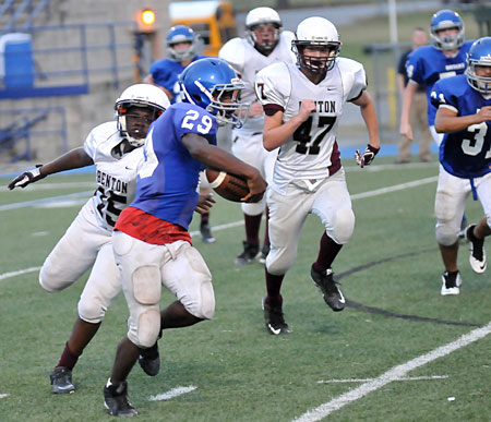 Arthur Woods (29) slips a tackle as he turns the corner. (Photo by Kevin Nagle)