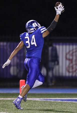 Madre Dixon celebrates as he reaches the end zone after scooping up a Cabot fumble. (Photo by Rick Nation)