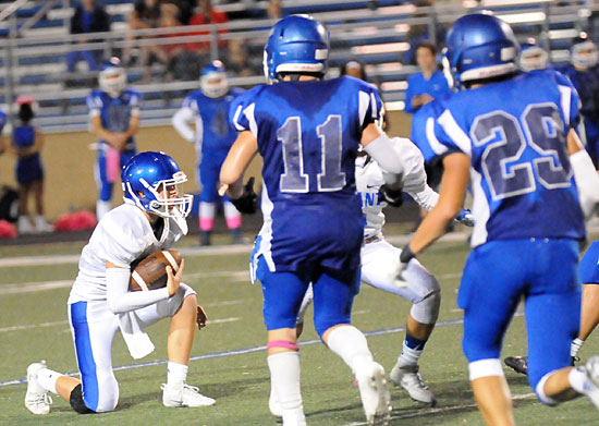 Quarterback Jake Meaders takes a knee at the end of Thursday's game. (Photo by Kevin Nagle)