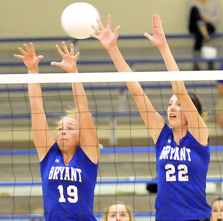 Grace Sams (19) and Truli Bates (22) reach for a block. (Photo by Kevin Nagle)