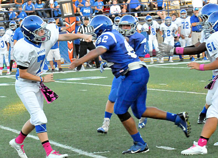 Under pressure from Bryant Blue defender Braden Frederick (82), Bryant White quarterback Aiden Adams releases a pass. (Photo by Kevin Nagle)