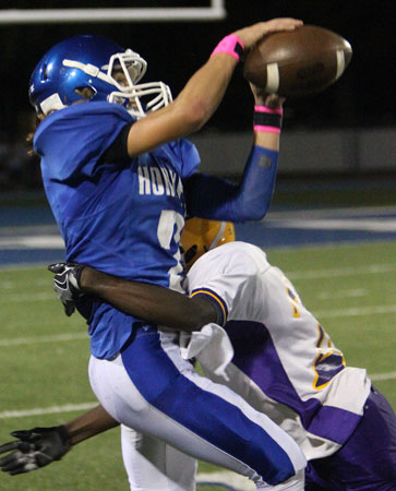 Gavin Wells tries to haul down a pass as Catholic's Isaac Leggett tries to break it up. (Photo by Rick Nation)