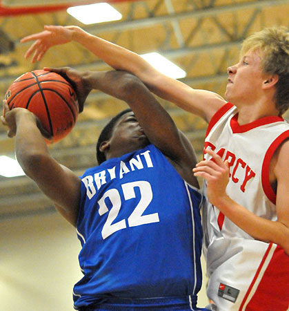 Connor Coleman (22) is hacked as he goes up for a shot inside. (Photo by Kevin Nagle)