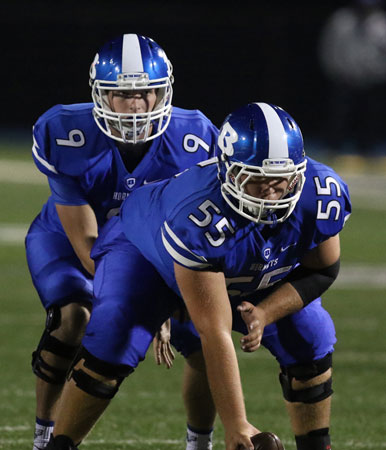 Preston Kyzer (55) prepared to snap the ball to Beaux Bonvillain. (Photo by Rick Nation)