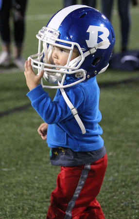 A future Hornet tries on a helmet after Friday's game. (Photo by Rick Nation)