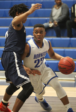 Marquelle Barnes tries to drive around a J.A. Fair defender. (Photo by Rick Nation)