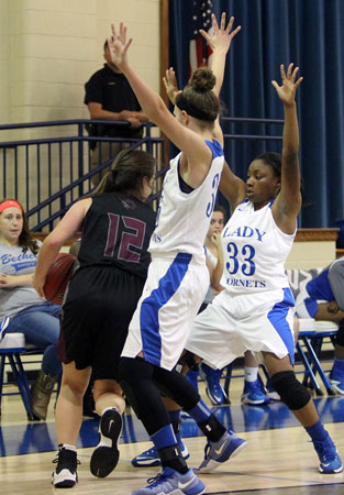 Bryant's McKenzie Muse and Tyianna Robinson trap a Benton ball-handler. (Photo by Rick Nation)