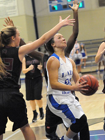 Maddie Scifres tries to find a shot in the heart of the Benton defense. (Photo by Kevin Nagle)