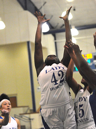 Mekeycia Baker reaches for a rebound. (Photo by Kevin Nagle)