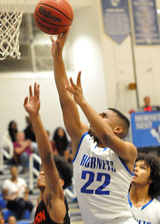 Marquelle Barnes reaches high to get a shot away at the rim. (Photo by Kevin Nagle)