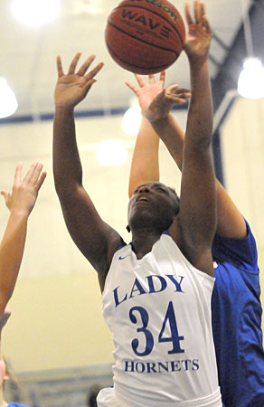 Ivory Russ gets fouled from behind as he puts up a shot inside. (Photo by Kevin Nagle)