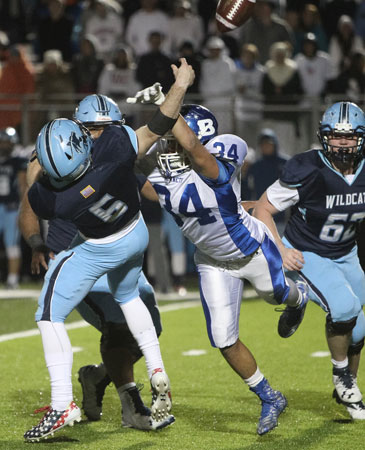 Madre Dixon drills Har-Ber quarterback Payton Copher as he was about to pass. Bryant's Kajuan Robinson picked it off. (Photo by Kevin Nagle)