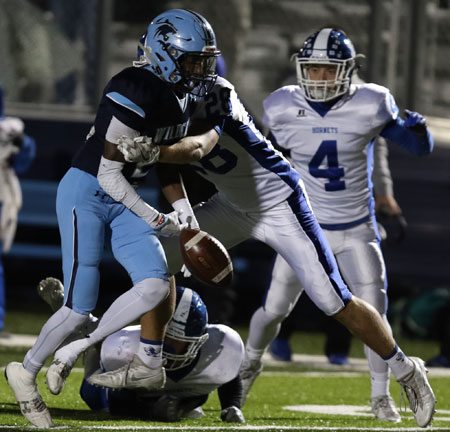 Brooks Ellis hits Har-Ber's Tevin Eckwood, jarring the ball loose. (photo by Rick Nation)