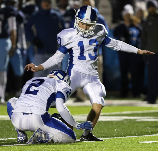 Hayden Ray boots the ball out of a hold by Landon Smith. (Photo by Rick Nation)