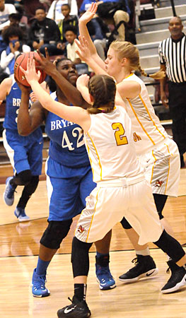 Mekeycia Baker looks for room for a shot against a double-team. (Photo by Kevin Nagle)