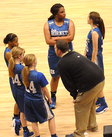 Bryant White coach Ben Perry instructs his players during a timeout Monday night. (Photo by Kevin Nagle)