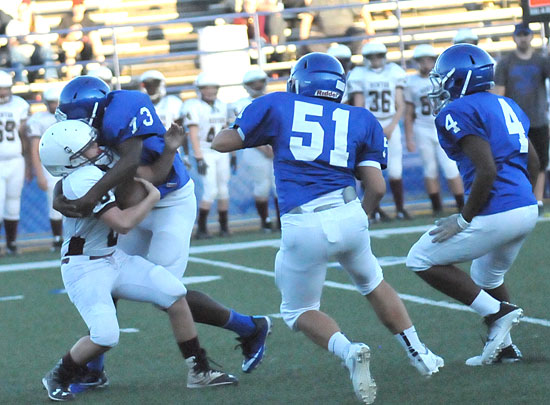 Gavin Bronson (73) sacks Benton quarterback Garrett Brown as help arrives from Christian Del Castillo (51) and Connor Coleman (4). (Photo by Kevin Nagle)