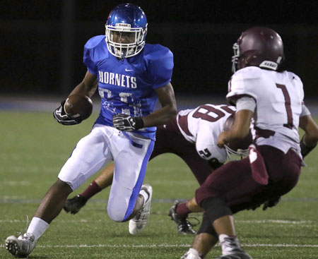 Ahmad Adams turns the corner after evading Benton's Jackson Drewery (28). Daeshawn Ward looks to make a tackle. (Photo by Rick Nation)