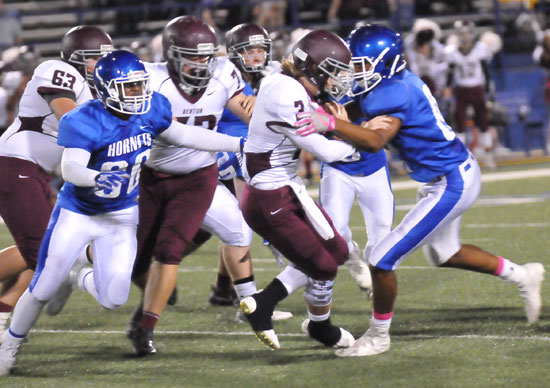 A pair of Bryant defenders including Austin Bailey (80) descend on Benton quarterback Peyton Hudgins. (Photo by Rick Nation)