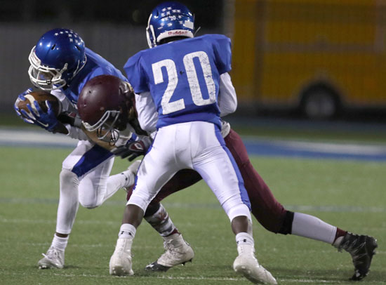 Trevon Herron (20) tries to block for Darrick Rose after an interception. (Photo by Rick Nation)