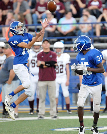 Devyn Spurgeon (14) leaps up to field an onside kick as teammate La'Quav Brumfield (35) looks back. (Photo by Kevin Nagle)