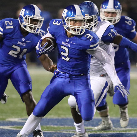 Reece Coates (3) looks for running room after picking up blocks from Cameron Coleman (21) and Chandler Davis (68). (Photo by Rick Nation)