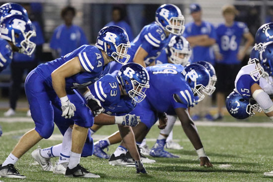 Bryant defenders Nathan Mayes (44), Hayden Knowles (33), Kajuan Robinson (99) and Brooks Ellis (28) await the snap. (Photo by Rick Nation)