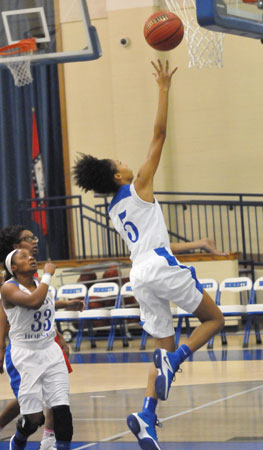 Jada Deaton takes a shot as Tiyanna Robinson trails the play. (Photo by Kevin Nagle)